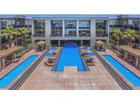 Beautiful resort-style pool area with cabanas and lounge chairs for relaxing and enjoying the sun at 8925 W Flamingo Rd # 310, Las Vegas, NV 89147