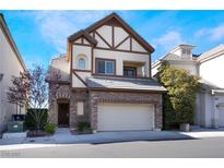 Charming two-story home features a stone facade, attached two-car garage, and well-maintained landscaping at 9165 Tudor Park Pl, Las Vegas, NV 89145