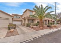 Charming two-story home with a well-manicured lawn and a large palm tree in the front yard at 9788 Altadena St, Las Vegas, NV 89183