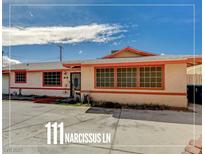 Charming single-story home featuring a large front yard and red-trimmed windows at 111 Narcissus Ln, Las Vegas, NV 89107