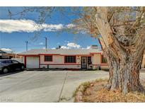 Charming single-story home featuring a spacious driveway and mature tree in the front yard at 111 Narcissus Ln, Las Vegas, NV 89107