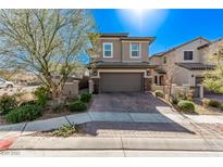 Charming two-story home with desert landscaping and a paved driveway on a sunny day at 173 Volti Subito Way, Henderson, NV 89011