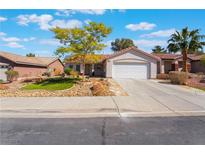 Charming single-story home featuring a well-maintained landscaped yard and a two-car garage at 206 Lynbrook St, Henderson, NV 89012