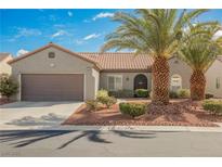 Charming single-story home featuring desert landscaping, a tile roof, and a two-car garage at 2306 Valley Cottage Ave, Henderson, NV 89052