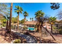 A beautiful pool area surrounded by mature palm trees and lush landscaping offers residents a relaxing outdoor retreat at 231 W Horizon Ridge Pkwy # 1011, Henderson, NV 89012