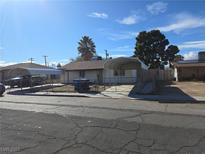 Charming single-story home featuring dual carport and a chain-link fenced yard at 2481 San Marcos St, Las Vegas, NV 89115