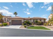 Charming single-story home with a tile roof, arched entryway, and desert-friendly landscaping at 2665 Chateau Clermont St, Henderson, NV 89044