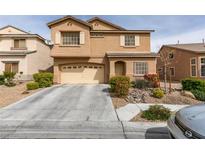 Charming two-story home features a well-manicured front yard, complemented by a two-car garage and a welcoming entrance at 312 Sierra Breeze Ave, North Las Vegas, NV 89031