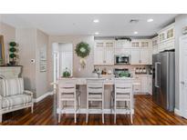 Bright kitchen with white cabinets, stainless steel appliances, and an island with bar seating at 3185 Mura Del Prato Ave, Henderson, NV 89044