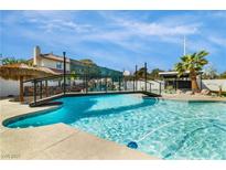 Inviting pool with bridge and tiki hut, perfect for outdoor entertaining at 3911 Kamden Way, Las Vegas, NV 89119