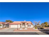 Charming single-story home featuring a well-manicured yard, desert landscaping, and a spacious two-car garage at 5604 Ocean Pines Cir, Las Vegas, NV 89130