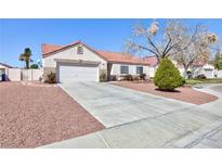 Charming single-story home featuring a two-car garage and desert landscaping at 5927 Tropical Palm Ct, North Las Vegas, NV 89031
