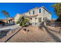 Charming two-story home with desert landscaping, a two-car garage, and well-maintained front yard at 6104 Talbot Springs Ct, North Las Vegas, NV 89081