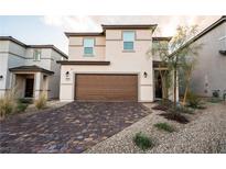 Charming two-story home featuring a two-car garage and a brick-paved driveway at 6129 Rose Springs Ave, Las Vegas, NV 89130