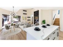 Bright living room features contemporary decor, fireplace, and wood floors at 6628 Silver Penny Ave, Las Vegas, NV 89108