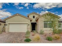 Charming one-story home featuring a stone facade, low maintenance desert landscaping, and a two-car garage at 864 Klamath Springs St, Henderson, NV 89011