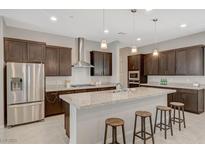 Modern kitchen features dark wood cabinetry, granite countertops, and stainless steel appliances at 864 Klamath Springs St, Henderson, NV 89011