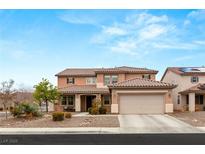 Inviting two-story home featuring a tile roof, desert landscaping, and an attached two-car garage at 8719 Melissa Meadows St, Las Vegas, NV 89131