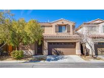 Charming two-story home featuring a well-maintained front yard and a two-car garage at 9475 Stillwater Bend Ln, Las Vegas, NV 89178
