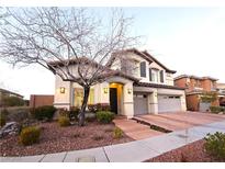 Inviting two-story home featuring a well-manicured front yard and an attached two-car garage at 11660 Intervale Rd, Las Vegas, NV 89135
