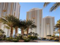 Las Vegas high rise condo exterior with palm trees and bright blue sky at 135 E Harmon Ave # 616, Las Vegas, NV 89109