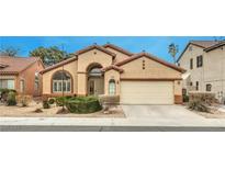 Charming single-story home with a desert landscape and a two-car garage at 1970 Jasper Creek Pl, Las Vegas, NV 89123