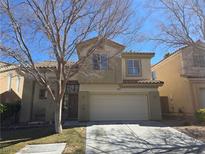 Two-story home featuring desert landscaping, tile roof, and a two-car garage at 2012 Nightrider Dr, Las Vegas, NV 89134