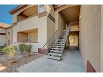 Condominium building exterior with stairwell access and neutral stucco facade and desert landscaping in a sunny environment at 231 W Horizon Ridge Pkwy # 426, Henderson, NV 89012