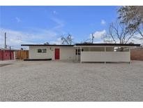 Charming single-story home with a modern design, red door, and low-maintenance landscaping at 2837 Reynolds Ave, North Las Vegas, NV 89030