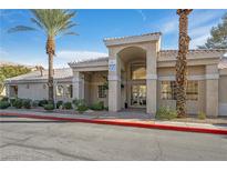Attractive building exterior with desert landscaping, and palm trees under a bright blue sky at 3924 Quiet Pine St # 201, Las Vegas, NV 89108