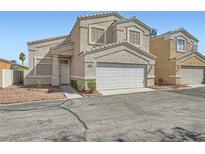 Charming two-story townhome featuring a two-car garage and low-maintenance landscaping at 5252 Mineral Lake Dr, Las Vegas, NV 89122