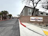 Cimarron Hills community sign with condo buildings in the background and street view at 6160 Rumrill St # 207, Las Vegas, NV 89113