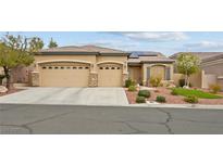 Charming single-story home featuring a three-car garage, a tiled roof, and stone accents at 10704 Warrior Ct, Las Vegas, NV 89135