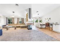 Bright, open-concept living and dining area with modern lighting and neutral decor at 124 Beach Oak Ave, Henderson, NV 89002