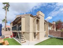 Charming condo featuring a private deck, desert landscaping, and stair access on a sunny day at 1312 Georgia Ave # D, Boulder City, NV 89005