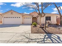Charming single-story home with three-car garage, desert landscaping, and a welcoming front porch at 1605 Silver Slipper Ave, Henderson, NV 89002