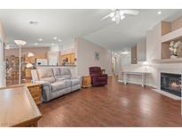 Bright living room featuring hardwood floors, fireplace, and neutral paint palette at 1605 Silver Slipper Ave, Henderson, NV 89002