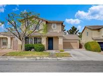 Charming two-story home featuring lush landscaping and a well-manicured lawn, under a bright blue sky at 2374 Falsetto Ave, Henderson, NV 89052