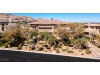 Beautiful home with lush landscaping, mature trees, and a welcoming entrance at 30 Meadowhawk Ln, Las Vegas, NV 89135