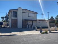Two-story home with a mix of brick and siding, showcasing a classic suburban design and front yard at 3009 Merritt Ave, Las Vegas, NV 89102