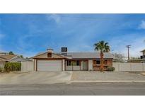Charming single-story home featuring a two-car garage, brick accents, and well-maintained landscaping at 4678 San Benito St, Las Vegas, NV 89121