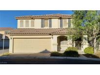 Two-story home featuring a two-car garage and well-maintained landscaping in a residential area at 8120 Finch Feather St, Las Vegas, NV 89143