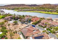 Stunning aerial view of luxury homes, lake, golf course, and mountains in a beautiful lakeside community at 9 Rue Grimaldi Way, Henderson, NV 89011