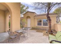 Inviting front yard with a charming seating area and well-maintained landscaping at 10505 Bambola Pl, Las Vegas, NV 89135