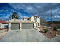 Charming home featuring a two-car garage with a spacious driveway and simple desert landscaping at 172 Cloudcrest Dr, Henderson, NV 89015