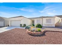 Charming single-story home with a well-manicured front yard and attached two-car garage at 3015 Extravagant Ave, North Las Vegas, NV 89031