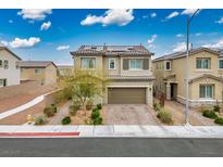 Charming home with a two-car garage, beautiful landscaping, and solar panels on the roof at 4606 Engage St, North Las Vegas, NV 89031
