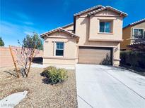 Charming two-story home with a desert landscape and a two car garage on a bright day at 4908 Desert Lime Ct, Las Vegas, NV 89148