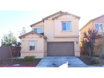 Two-story home with a neutral color scheme, attached garage, and well-maintained front yard at 4908 Desert Lime Ct, Las Vegas, NV 89148