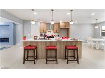 Beautiful open-concept kitchen with a large island, pendant lighting, and stainless steel appliances at 4986 Palmyra Ave, Las Vegas, NV 89146
